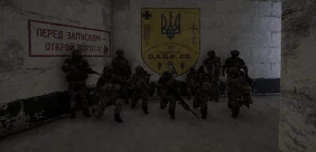 Squad in a bunker in front of the painted D.A.G.R. shield